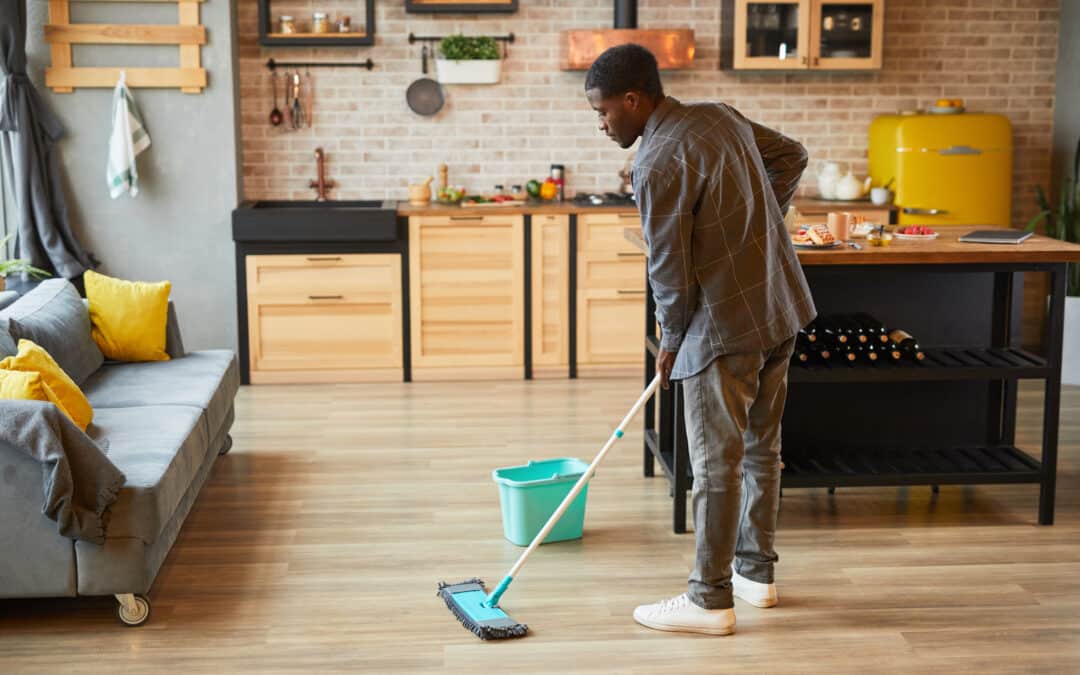 Young Man Cleaning Floors at Home