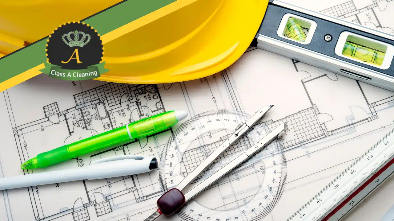 Hard hat and other constructions items like blueprints with Class A Clean logo in top left.